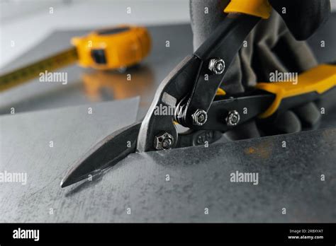 Tinsmith Cutting Metal Sheet With Tin Snips Stock Photo Alamy