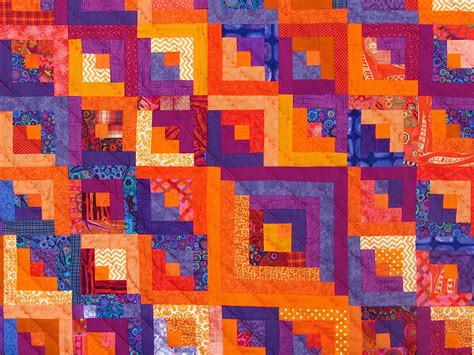 Learn how to quilt with easy quilt patterns that teach you the basics! Orange explains it all: log cabin quilt in orange and purple