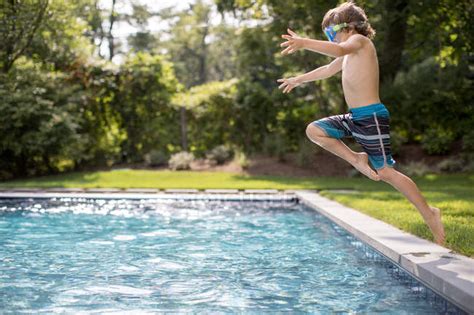 Мальчик прыгает в открытый бассейн — Хэмптонс Очки для плавания