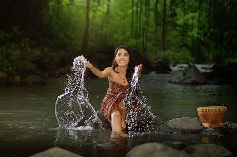 Hd Wallpaper Woman Sitting On Rock On River During Daytime Village