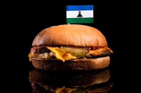 Lesotho Flag On Top Of Hamburger Isolated On Black Background Stock