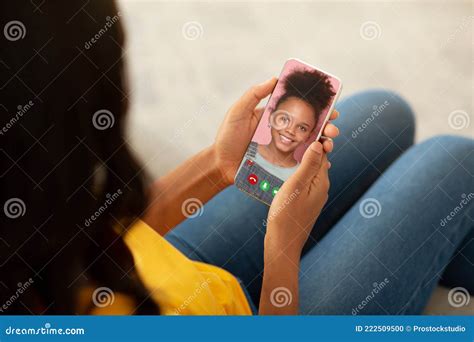 Millennial Black Mother Using Cellphone To Speak To Her Lovely Teen Daughter Online From Home