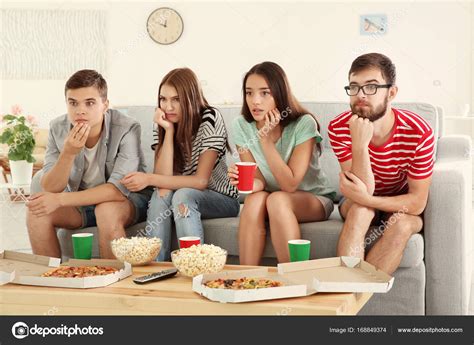Friends Watching Tv At Home — Stock Photo © Belchonock