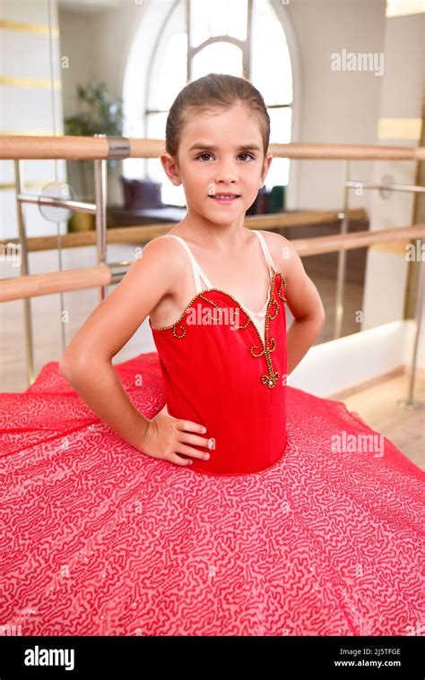 Cute Portrait Of A Beautiful Little Ballerina In A Performance Red Dress With Pink Tutu She