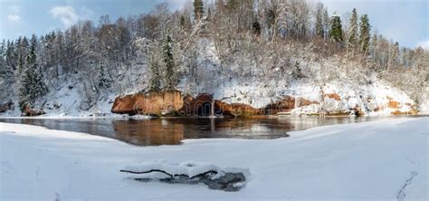 Panoramic Winter Landscape With Snowy Sandstone Cliff And Frozen Ice