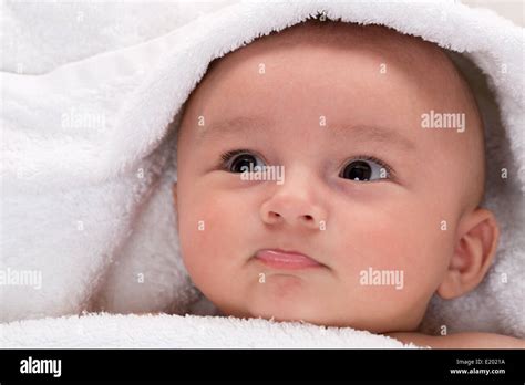 Portrait Of A Baby Lying In Bed In A Sheet Stock Photo Alamy