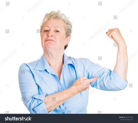 Closeup Portrait Of Smiling Senior Mature Woman Flexing Muscles Showing
