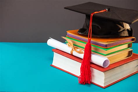 Books Diploma And Graduation Cap With Tassel On Blue With Copy Space