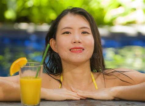 Young Beautiful And Happy Asian Chinese Woman In Bikini Enjoying Vacation At Swimming Pool