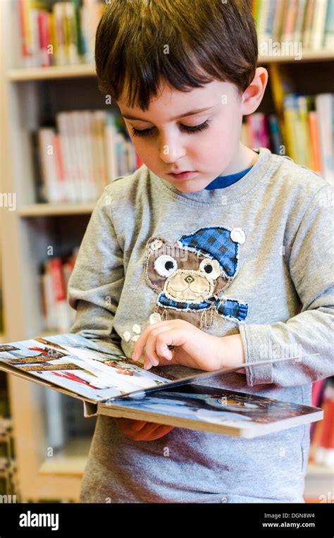 Child Reading Book At The Public Library Stock Photo Alamy
