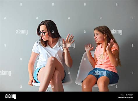 Furious young mother in a discussion with her teenage daughter