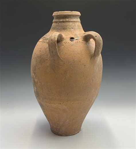 Lot 386 A Terracotta Vessel With Twin Handles