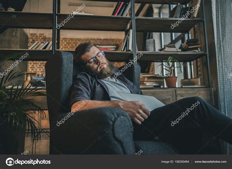 Man Sleeping In Armchair Stock Photo By ©igorvetushko 158350464