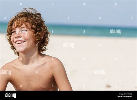 Spain Boy Sitting On Beach Smiling Stock Photo Alamy