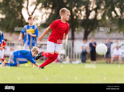 Young Boys Playing Football Soccer Game On Sports Field Stock Photo Alamy