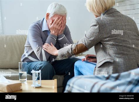Therapist Comforting Senior Patient Stock Photo Alamy