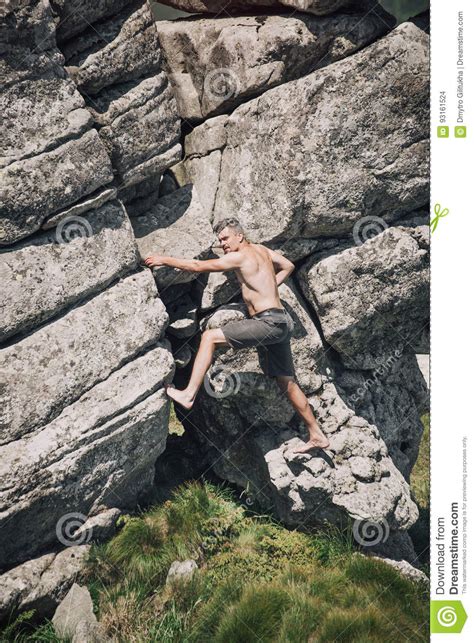 Athletic Man Climbing On The Mountain Rock Stock Photo