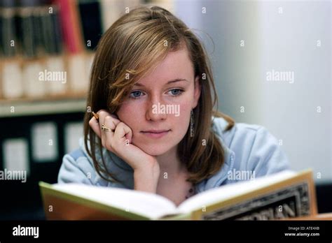 Young Woman Student Reading And Studying In A Library Stock Photo Alamy