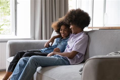 African Teenage Couple In Love Resting On Sofa Enjoy Talk Stock Image Image Of Ethnicity