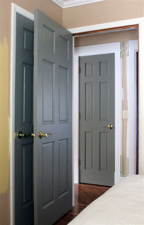 Two Gray Doors Are Open In A Bedroom