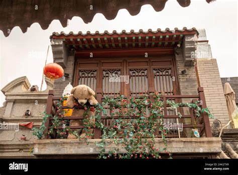 Large Teddy Bear On Balcony Looking Down Old City Beijing China