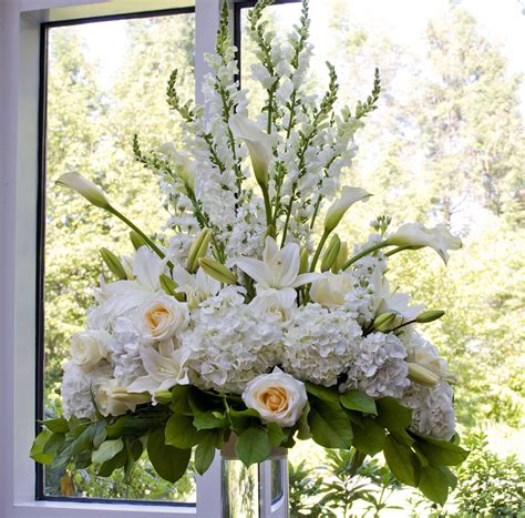tall ceremony arrangement of white hydrangeas white and cream roses lilies calla lil… tall