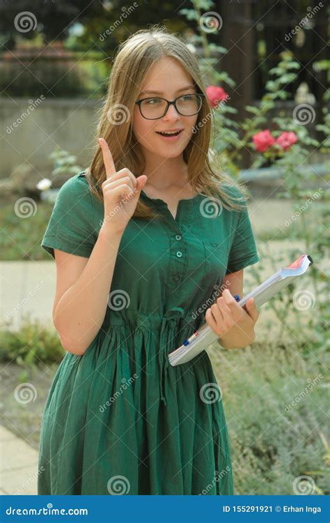 Teenage Cute Young Girl Student In Black Eyeglasses Holding Books