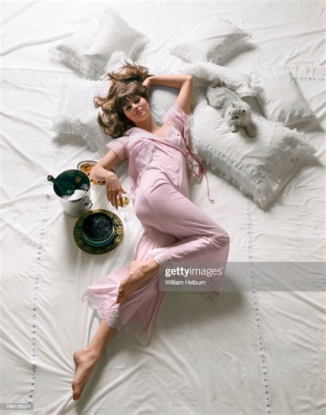 Model Sandra Hilton Poses In Pink Lingerie Lying On Pink Sheets For