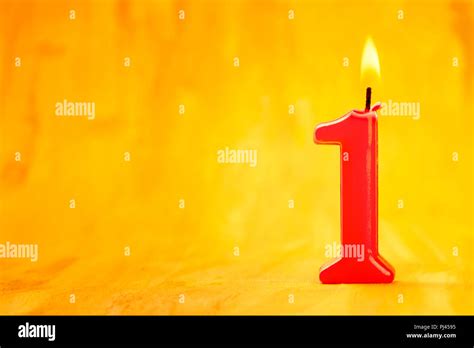 Red Number One Burning Candle On A Golden Background With Copyspace