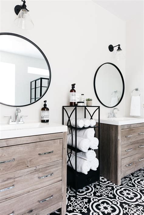 I love the brackets that give it a farmhouse industrial style. Stunning black and white bathroom with natural wood vanity ...