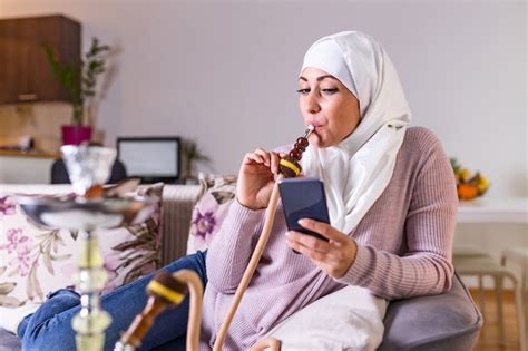 premium photo muslim woman smoking shisha at home arab girl smoking hookah