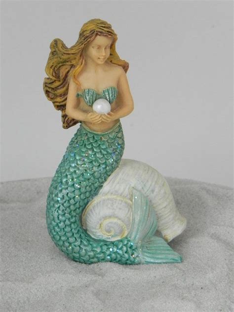 A Beautiful Mermaid That Is Resting On A Shell Shell Be Perfect For