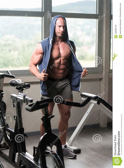 Handsome Muscular Man Flexing Muscles In Gym Stock Photo Image Of