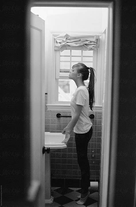 Woman Standing In Bathroom By Stocksy Contributor Ryan Muirhead