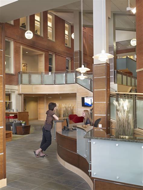 A Woman Is Standing In An Office Lobby