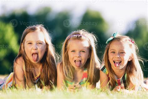 Three Little Girls Sticking Their Tongues Out 9367112 Stock Photo At