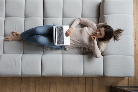 Pensive Serious 20s Girl Resting On Couch Using Laptop Stock Image Image Of Learn Couch