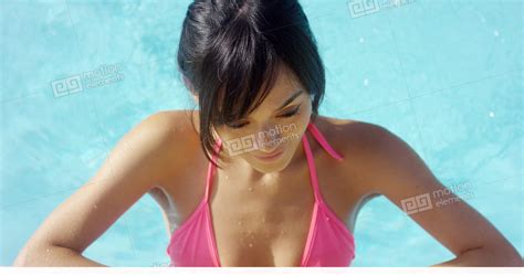 Smiling Brunette In Pink Bikini Stands In Pool Stock Video Footage