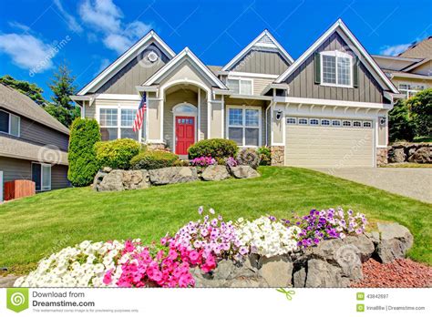 American House With Beautiful Landscape And Vivid Flowers Stock Image