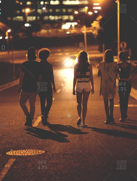 Teens Walking On A Road At Night Stock Photo Offset