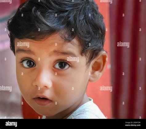 An Asian Indian Baby With Raised Eyebrows Looking At The Camera Stock
