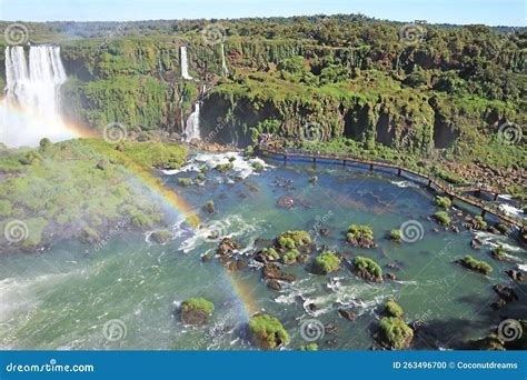 Panoramic Aerial View Of A Rainbow Over Iguazu Falls With Many Of