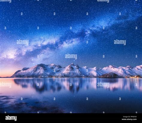 Bright Milky Way Over Snow Covered Mountains And Sea At Night In Winter