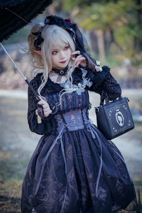Dressed In A Black Gothic Lolita Dress With Grey Patterns And Frills