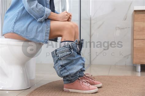 Woman Suffering From Hemorrhoid On Toilet Bowl In Rest Room Closeup Stock Photo Download On
