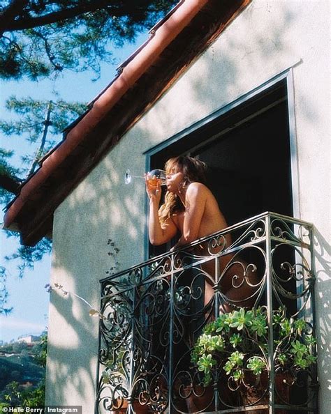 Halle Berry Poses Nude On A Balcony As She Sips From A Glass Of