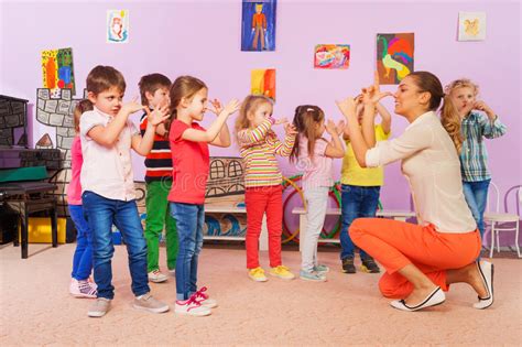 Games also make great rewards for students who do well in class, or as a 'treat' if the class focuses on their core work during the body of the lesson. Kids Repeat After Teacher Gesture In Class Stock Image ...