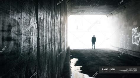 Man Walking Through Tunnel — Mysterious Male Stock Photo 130715096
