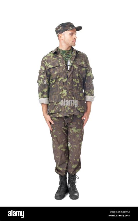 Full Length Portrait Of Young Army Soldier Standing In Attention And
