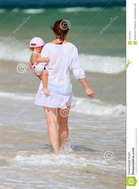 Mother And Baby Walking Along Beach Stock Image Image Of